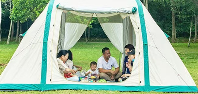 Tent pitched beside the car for camping outdoors